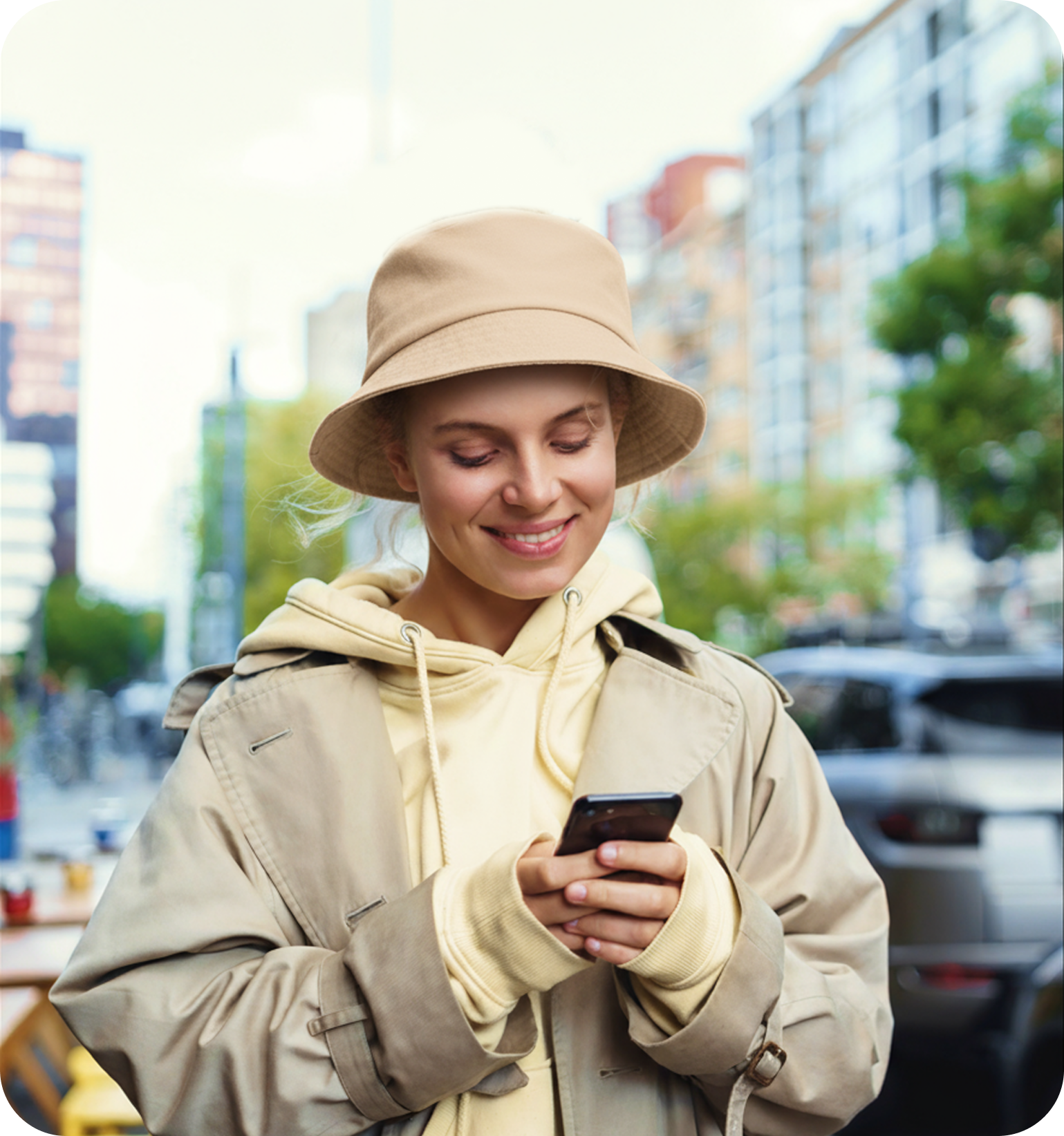 Woman smiling while using her phone